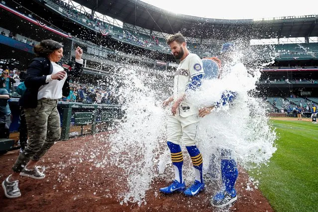 Seattle Mariners right fielder Jesse Winker (27) is doused with a water cooler during a postgame interview after hitting a walk-off RBI-single against the Kansas City Royals during the twelfth inning at T-Mobile Park in Seattle, Washington on April 24, 2022. Seattle defeated Kansas City, 5-4. (Photo by Joe Nicholson/USA TODAY Sports)