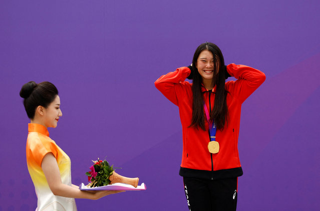 Gold medallist Japan's Hinano Kusaki poses on the podium during the medal ceremony for the women's park skateboarding event during the 2022 Asian Games in Hangzhou in China's eastern Zhejiang province on September 25, 2023. (Photo by Tingshu Wang/Reuters)