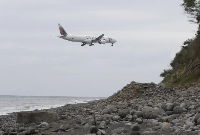 An airplane flies over the Jamaique beach in Saint-Denis on the French Indian Ocean island of La Reunion, August 3, 2015. (Photo by Jacky Naegelen/Reuters)