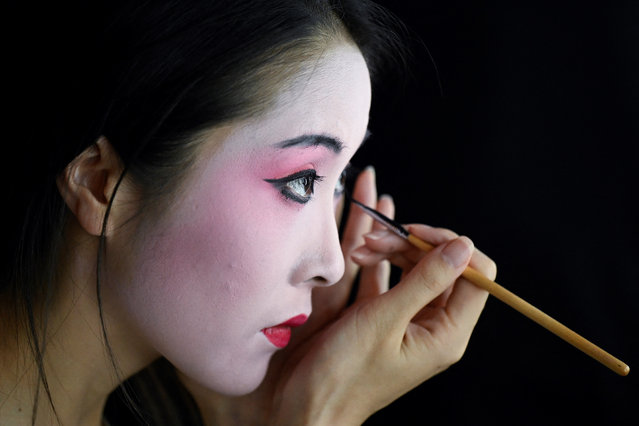 A model prepares backstage before the Am/Jasmine collection by Chen Liang during the China Fashion week in Beijing on September 5, 2024. (Photo by Wang Zhao/AFP Photo)