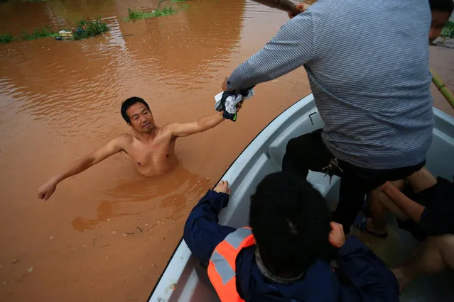 Rescuers save a man wading in flood water after heavy rainfall in Hengyang, Hunan Province, China, June 15, 2016. (Photo by Reuters/Stringer)