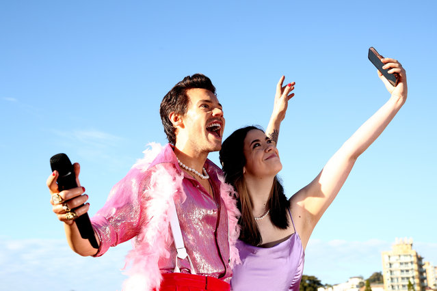 People take selfies as a English singer-songwriter Harry Styles wax figure is unveiled on Coogee Beach on July 18, 2023 in Sydney, Australia. (Photo by Don Arnold/WireImage)