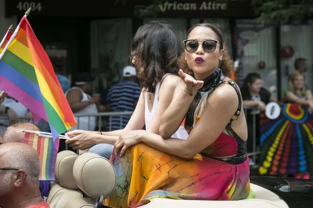 “Chicago Fire” actress Monica Raymund, the Grand Marshal for the 47th annual Chicago Pride Parade, blows a kiss as the parade moves through the North Side of Chicago on Sunday, June 26, 2016. (Photo by Ashlee Rezin/Chicago Sun-Times via AP Photo)