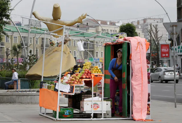 A fruit vendor is pictured beside a street in downtown Ulaanbaatar, Mongolia, June 28, 2016. (Photo by Jason Lee/Reuters)