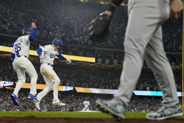 Los Angeles Dodgers' Freddie Freeman, middle, celebrates his walk-off grand slam home run against the New York Yankees during the 10th inning in Game 1 of the baseball World Series, Friday, October 25, 2024, in Los Angeles. (Photo by Ashley Landis/AP Photo)