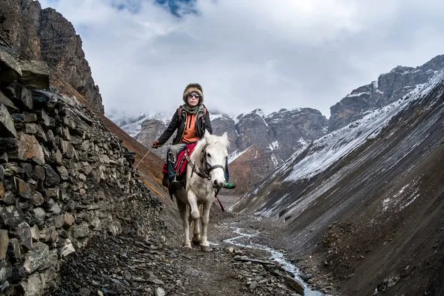 “As we approached the start of the Thorong La pass in Nepal this horseman came towards us. I managed to get a shot before he got by us on the narrow path”. (Photo by Keith Urry/The Guardian)