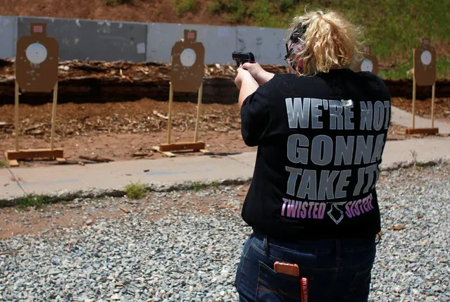 Mallory Washburn shoots at targets during a firearms training class attended by members of the Pink Pistols, a national pro-gun LGBT organization, at the PMAA Gun Range in Salt Lake City, Utah, U.S., July 1, 2016. (Photo by Jim Urquhart/Reuters)