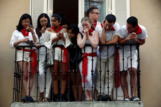 Revellers look at a crowd of runners from a balcony as the wait for the start of the third running of the bulls at the San Fermin festival in Pamplona, northern Spain, July 9, 2016. (Photo by Susana Vera/Reuters)
