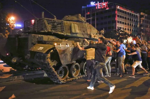 People react near a military vehicle during an attempted coup in Ankara, Turkey, July 16, 2016. (Photo by Tumay Berkin/Reuters)
