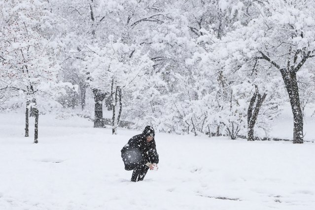 A woman enjoys the snow at the Gyeongbok Palace on November 27, 2024 in Seoul, South Korea. According to the state weather agency, more than 16 centimeters of snow blanketed capital city Seoul on Wednesday, marking the biggest snowfall in November since modern weather observations began in 1907. (Photo by Chung Sung-Jun/Getty Images)