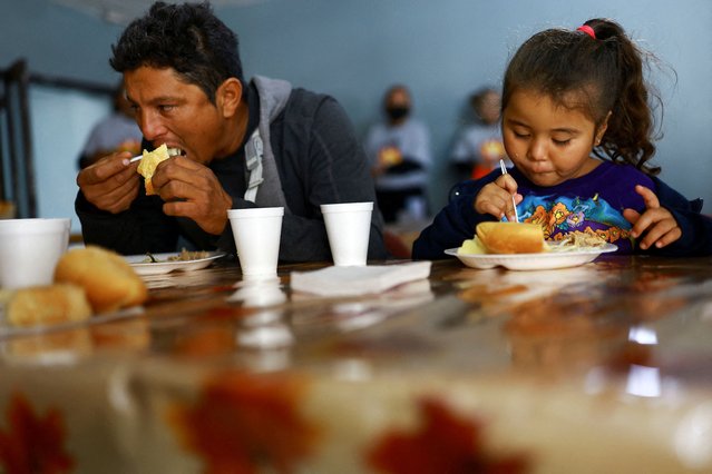 Govani Hernandez and her daughter Itzel Hernandez, migrants from Honduras trying to reach the United States to request asylum, eat as they celebrate the traditional Thanksgiving Day with a meal offered by members of the Renovados de Jesus church, in Ciudad Juarez Mexico on November 28, 2024. (Photo by Jose Luis Gonzalez/Reuters)