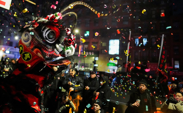 A dancer wearing a lion costume performs during a midnight Lunar New Year celebration, marking the Year of the Snake, in New York City's Chinatown section, in Manhattan, on January 29, 2025. (Photo by Adam Gray/Reuters)