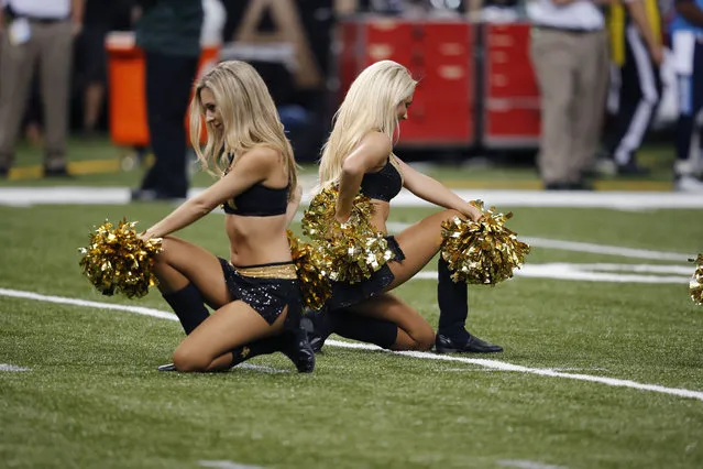 New Orleans Saints cheerleaders perform during an NFL preseason football game against the Tennessee Titans in New Orleans, Friday, August 15, 2014. (Photo by Bill Haber/AP Photo)