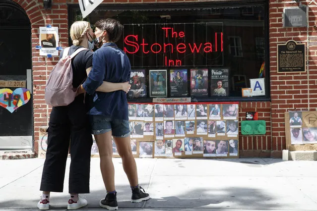 New York on June 15, 2020. Today the Supreme Court handed down a ruling that outlaws discrimination against homosexual and transgender workers. At the landmark Stonewall Inn in Manhattan people stopped to read the signs placed in front. (Photo by Tamara Beckwith/The New York Post)