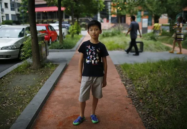 Yu Yan, who was born in 2004, poses for a photograph in Shanghai August 24, 2014.  “I want to have someone to play with” said Yan. (Photo by Carlos Barria/Reuters)