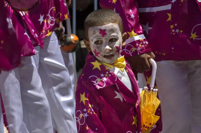 A member of a minstrel troupe marches in the city centre of Cape Town during the annual Tweede Nuwe Jaar (Second New Year) Cape Town Minstrels Carnival on January 2, 2018. The Tweede Nuwe Jaar (Second New Year) Cape Town Minstrels Carnival is the main public event of a series of competitions, performances, and carnivals that celebrate Cape Malay culture in the Western Cape Province, which sees more than 40 troupes, and nearly 1,000 members dressed with bright coloured costumes march while playing music and dancing, through the centre of Cape Town. The Tweede Nuwe Jaar celebration dates back to the time before slavery was abolished in the Cape colony, during which slaves were allowed to relax on the day following New Years Day. These troupes also aim at creating social cohesion, activities for youth, and connection with culture in the mostly impoverished crime-ridden communities in which the members live. (Photo by Rodger Bosch/AFP Photo)