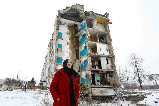 Member of the International Working Group on the Environmental Consequences of War and former Swedish Foreign Minister Margot Wallstrom stands next to an apartment building heavily damaged in the town of Borodianka, Kyiv region, Ukraine on February 10, 2024. (Photo by Valentyn Ogirenko/Reuters)