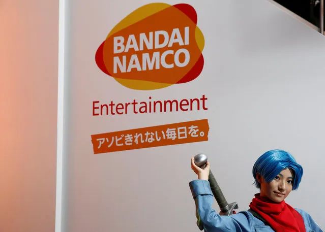A costume player poses in front of Bandai Namco Holdings' logo at Tokyo Game Show 2016 in Chiba, east of Tokyo, Japan, September 15, 2016. (Photo by Kim Kyung-Hoon/Reuters)