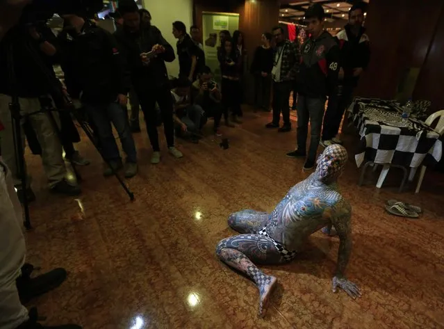 Matt Gone, also known as “The Checkered Man”, poses for the media during a tattoo convention in Bogota November 14, 2014. (Photo by Jose Miguel Gomez/Reuters)