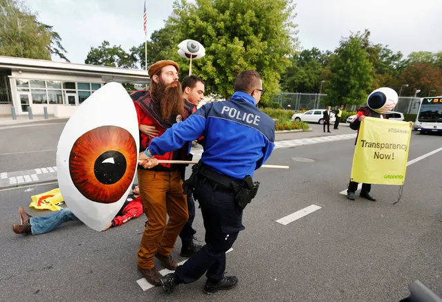 Geneva police forces remove Greenpeace activists during a demonstration against the trade agreements TTIP, CETA and TiSA in front of the U.S. Mission in Geneva, Switzerland, September 20, 2016. (Photo by Denis Balibouse/Reuters)