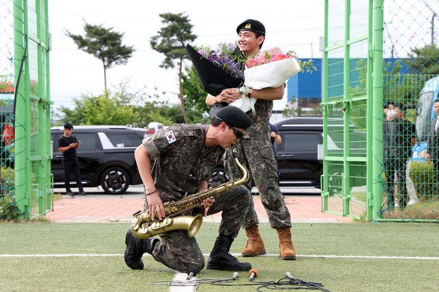 K-pop band BTS's members RM (L) and V (R) react after being discharged from a mandatory military service on June 10, 2025 in Chuncheon, South Korea. Four members of the K-pop group BTS's RM, V, Jimin and Jungkook will be discharged from their mandatory 18-month military service next week, the boy band's agency said. RM, the leader of the group, and V completed the 18-month mandatory military service, which is required for all able-bodied male citizens in South Korea before they turn 28, followed by Jimin and Jungkook the next day, according to BigHit Music. (Photo by Chung Sung-Jun/Getty Images)