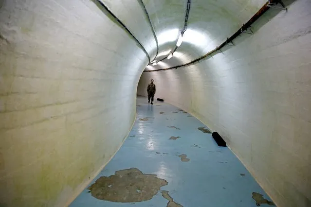 A member of the Armed Forces of Bosnia and Herzegovina walks through a tunnel in Josip Broz Tito's underground secret bunker (ARK) in Konjic, October 16, 2014. (Photo by Dado Ruvic/Reuters)