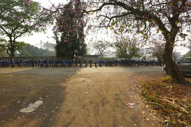 Schoolchildren queue outside their school in Harare, Zimbabwe, Monday, September 28, 2020. Zimbabwe schools have reopened in phases, but with smaller number of pupils,more teachers and other related measures to enable children to resume their education without the risk of a spike in COVID-19 infections. (Photo by Tsvangirayi Mukwazhi/AP Photo)