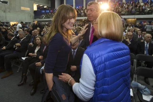 Carla Bruni-Sarkozy (centre L), wife of former French president Nicolas Sarkozy's, speaks with French deputy Patrick Balkany and his wife Isabelle at a political rally as Sarkozy campaigns for the leadership of the UMP political party in Boulogne-Billancourt, Paris suburb, November 25, 2014. (Photo by Philippe Wojazer/Reuters)