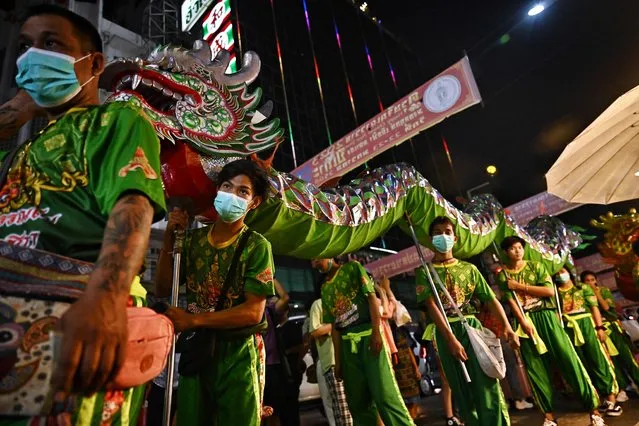 Dragon dancers perform in Chinatown in Bangkok on January 19, 2023, ahead of the Lunar New Year of the Rabbit, which falls on January 22. (Photo by Lillian Suwanrumpha/AFP Photo)