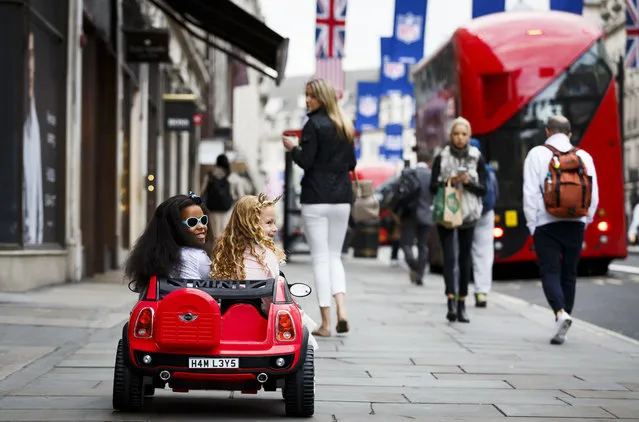 Ella Twigg and Queenie Chappell drive a BMW Mini Beechcomber as Hamley's announce it's top ten toys for Christmas at Hamleys on October 6, 2016 in London, England. (Photo by Tristan Fewings/Getty Images)