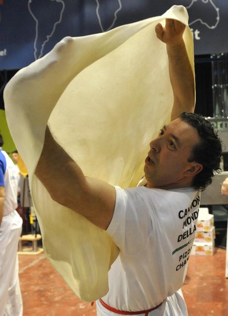 Giuseppe Conte, of Italy, performs with his dough during the freestyle event, part of the Pizza World Championships, in Parma, northern Italy, Wednesday, April 17, 2013. (Photo by Marco Vasini/AP Photo)