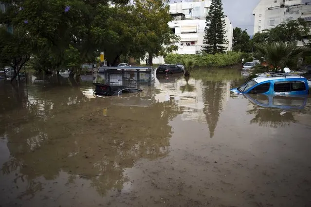 Vehicles are partially submerged in water on a flooded street in the southern city of Ashkelon, Israel, November 9, 2015. (Photo by Amir Cohen/Reuters)