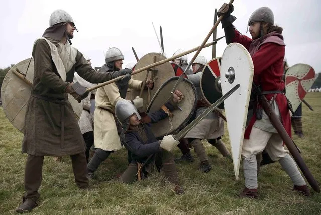 Re-enactors participate in a demonstration before a re-enactment of the the Battle of Hastings on the 950th anniversary of the battle, in Battle, Britain October 15, 2016. (Photo by Neil Hall/Reuters)