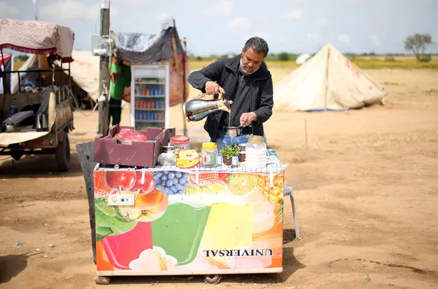 A Palestinian man sells tea and coffee during a tent city protest at Israel-Gaza border, in the southern Gaza Strip April 3, 2018. (Photo by Ibraheem Abu Mustafa/Reuters)