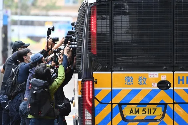 Members of the media surround a correctional services bus purportedly carrying pro-democracy activists Agnes Chow, Ivan Lam and Joshua Wong as it leaves the court in Hong Kong on November 23, 2020, after the three pleaded guilty to inciting a rally during pro-democracy protests in 2019, deepening the crackdown against Beijing's critics. (Photo by Peter Parks/AFP Photo)
