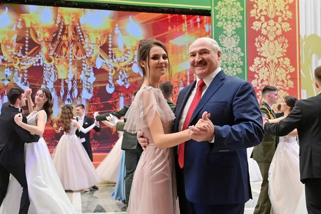 Belarus' President Alexander Lukashenko (R) dances with a woman during the New Year's Youth Ball in the Palace of Independence in Minsk, Belarus on December 29, 2020. A total of 314 young people from various Belarusian regions have been invited to the event, namely comprehensive and vocational school pupils, university and college students. (Photo by Maxim Guchek/TASS via Getty Images)