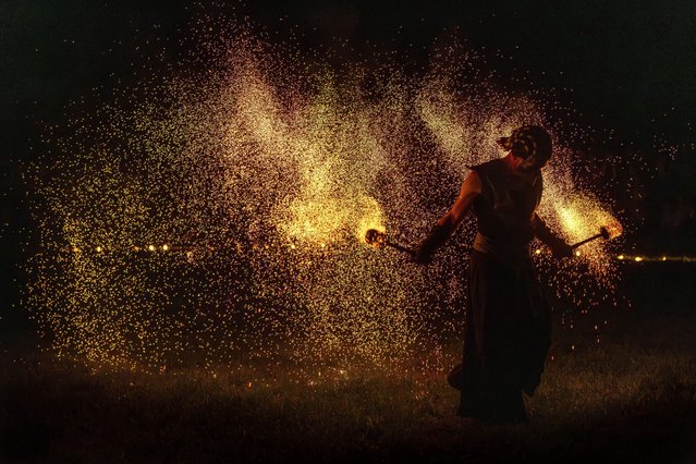 People participate in fire rituals during the Autumn Equinox celebration in Vilnius, Lithuania, Monday, September 22, 2025. (Photo by Mindaugas Kulbis/AP Photo)