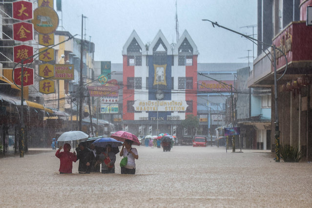 People wade through a flooded area in Hat Yai district, Songkhla, Thailand on November 22, 2025. (Photo by Roylee Suriyaworakul/Reuters)