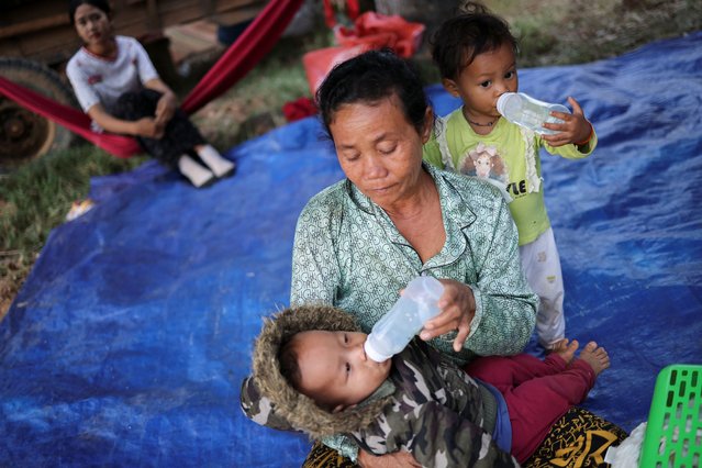 A woman feeds a child at a refugee camp after evacuation, amid deadly clashes between Thailand and Cambodia along a disputed border area, in Srei Snam, Siem Reap Province, Cambodia, on December 10, 2025. (Photo by Kim Hong-Ji/Reuters)