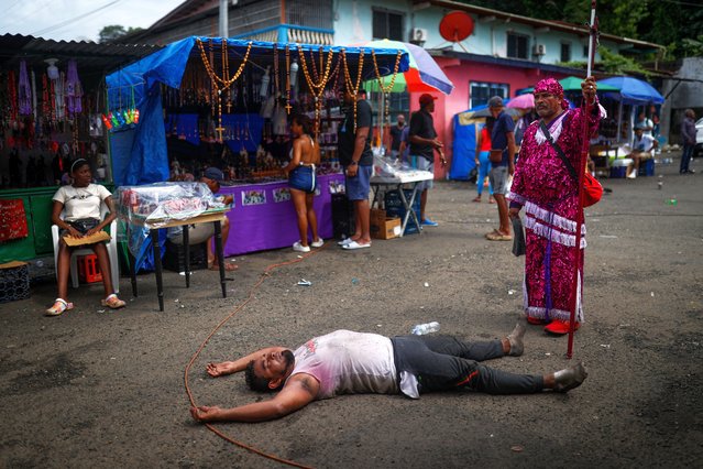 A devotee rests during a pilgramage to the 'Cristo Negro de Portobelo' on the path to San Felipe church in Portobelo, Panama, 21 October 2024. (Photo by Bienvenido Velasco/EPA/EFE)