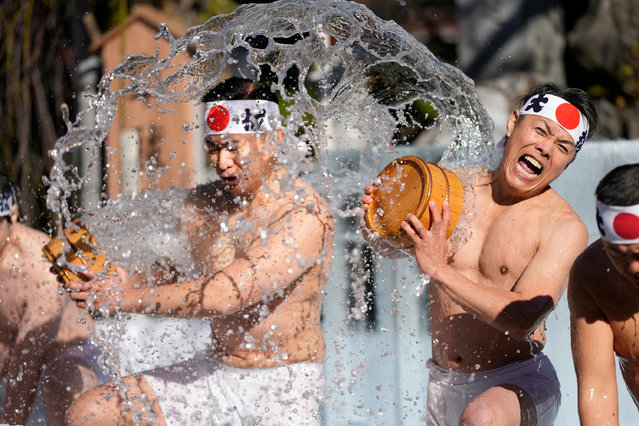 Shrine parishioners throw icy cold water on themselves during the annual cold-endurance festival at Kanda Myojin Shinto shrine in Tokyo, Saturday, January 18, 2025, a traditional Japanese way of purifying soul and praying for their health in the new year. (Photo by Eugene Hoshiko/AP Photo)