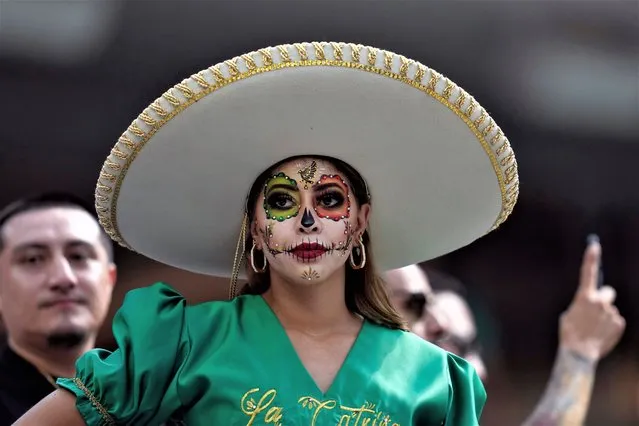 A fan has her face painted on the stands before a CONCACAF Gold Cup final soccer match between Mexico and Panama Sunday, July 16, 2023, in Inglewood, Calif. (Photo by Ashley Landis/AP Photo)