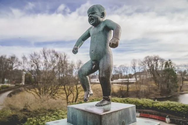 The bronze Sinnataggen sculpture by the well-known Norwegian sculptor Gustav Vigeland, in Vigelandsparken in Oslo, Tuesday April 6, 2021. A Norwegian museum says that the famous statue depicting a baby boy stomping his feet in anger that is considered a national treasure has been removed from a park in the capital, Oslo, for repairs after an unknown perpetrator or perpetrators vandalized it by trying to saw off its left ankle. (Photo by Stian Lysberg Solum/NTB via AP Photo)