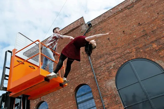 Aerialists Luka Owen and Daniel Connor perform with a Fork Lift Truck to mark the handover of the former Daimler Car Factory to Imagineer by the Wigley Group on April 14, 2021 in Coventry, England. The building will include a sound recording studio and edit suite, as well as a Sprung Dance Floor and Vertical Dance Wall. As well as providing a home for Imagineer’s innovative education and training programmes aimed at young people and people with disabilities. (Photo by Darren Staples/Getty Images)