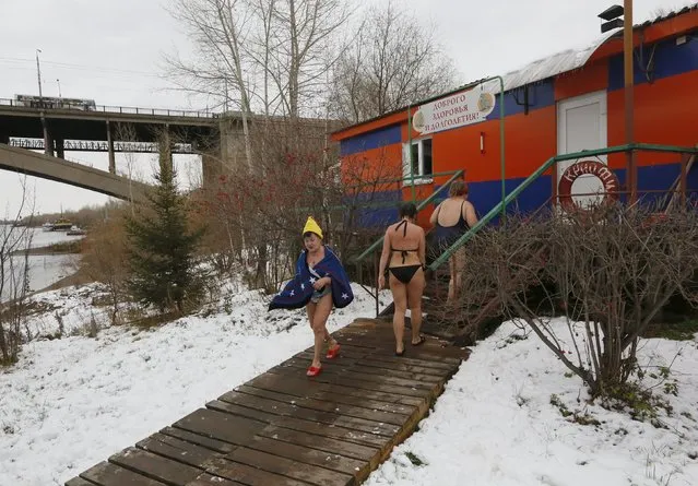 Members of the Cryophile winter swimmers club walk outside the wooden clubhouse on the banks of the Yenisei River in the Siberian city of Krasnoyarsk, Russia, October 25, 2015. (Photo by Ilya Naymushin/Reuters)