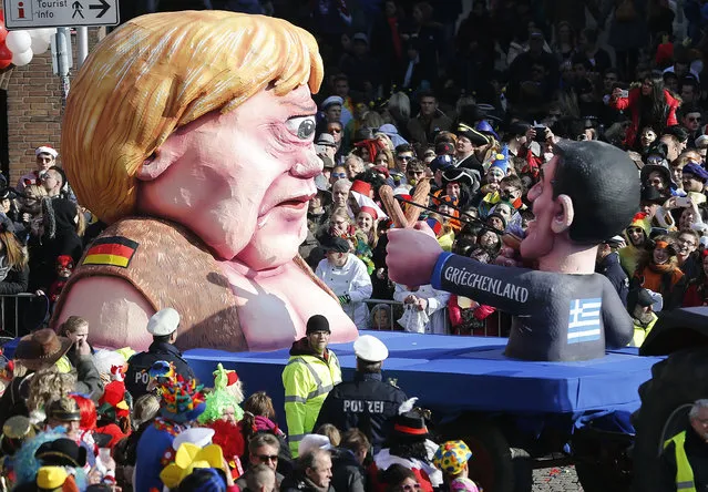 A carnival float depicting German Chancelor Angela Merkel  as a mythical Cyclops and Greek premier Alexis Tsipras attacking her  during the traditional Rose Monday carnival parade in Duesseldorf, Germany, Monday, February 16, 2015. (Photo by Frank Augstein/AP Photo)