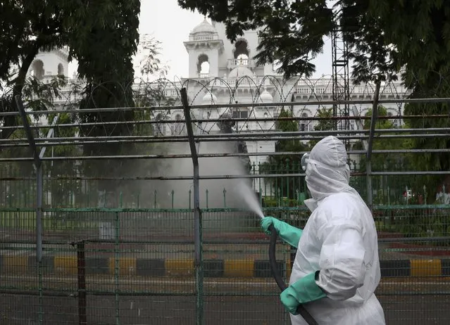 Members of disaster response force spray disinfectants as a precautionary measure against COVID-19 in Hyderabad, India, Monday, April 19, 2021. (Photo by Mahesh Kumar A./AP Photo)