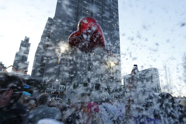 A heart-shaped balloon is surrounded by pillow feathers during The Great San Francisco Valentine's Day Pillow Fight, in San Francisco February 14, 2015. (Photo by Stephen Lam/Reuters)