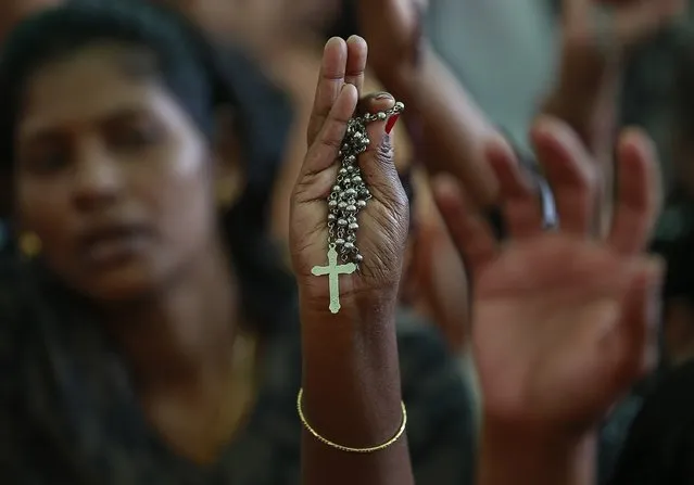 A protester holds a cross during a protest rally by hundreds of Christians against recent attacks on churches nationwide, in Mumbai February 9, 2015. Five churches in the Indian capital New Delhi have reported incidents of arson, vandalism and burglary. The latest was reported last week when an individual stole ceremonial items. (Photo by Danish Siddiqui/Reuters)