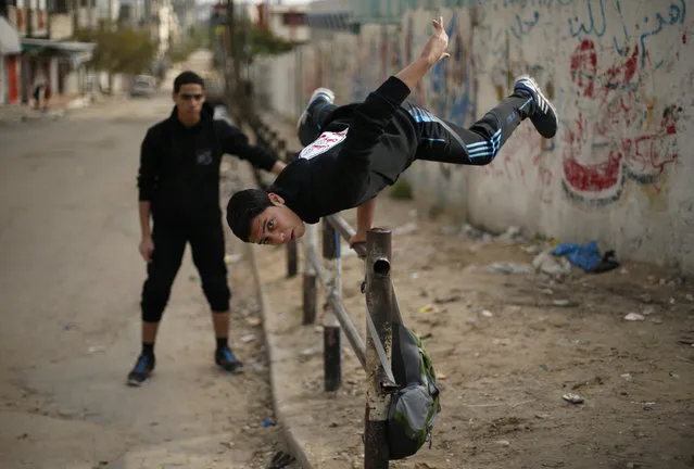 A Palestinian youth demonstrates his parkour skills on a street in Gaza City, January 15, 2016. (Photo by Suhaib Salem/Reuters)
